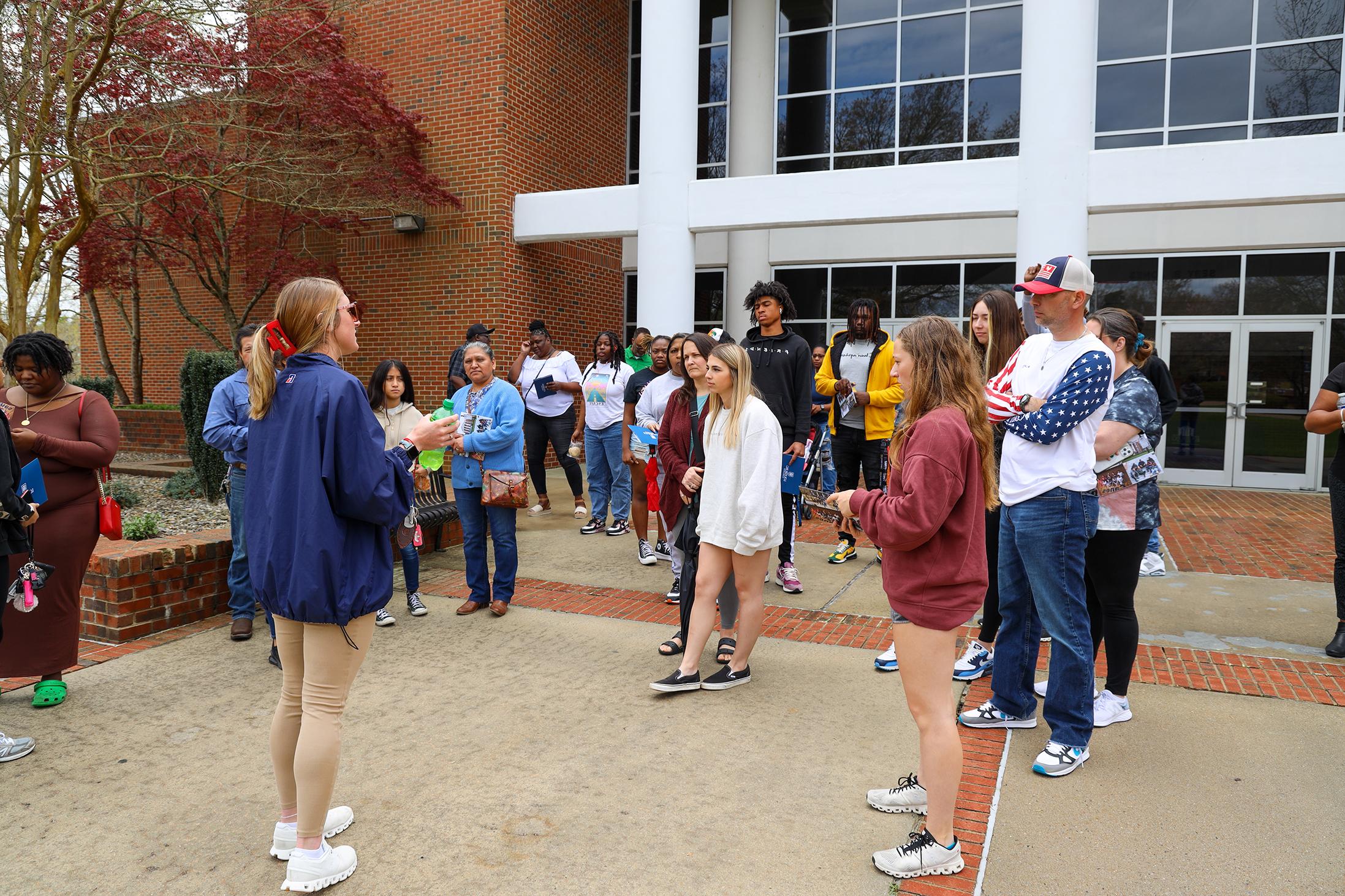 Student leading a group tour.